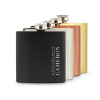 Set of four flasks in black, silver, gold, and bronze with 'Groomsman Cameron' engraving.