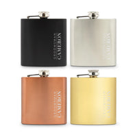 Four flasks in black, silver, bronze, and gold with 'Groomsman Cameron' engraving on a white background.
